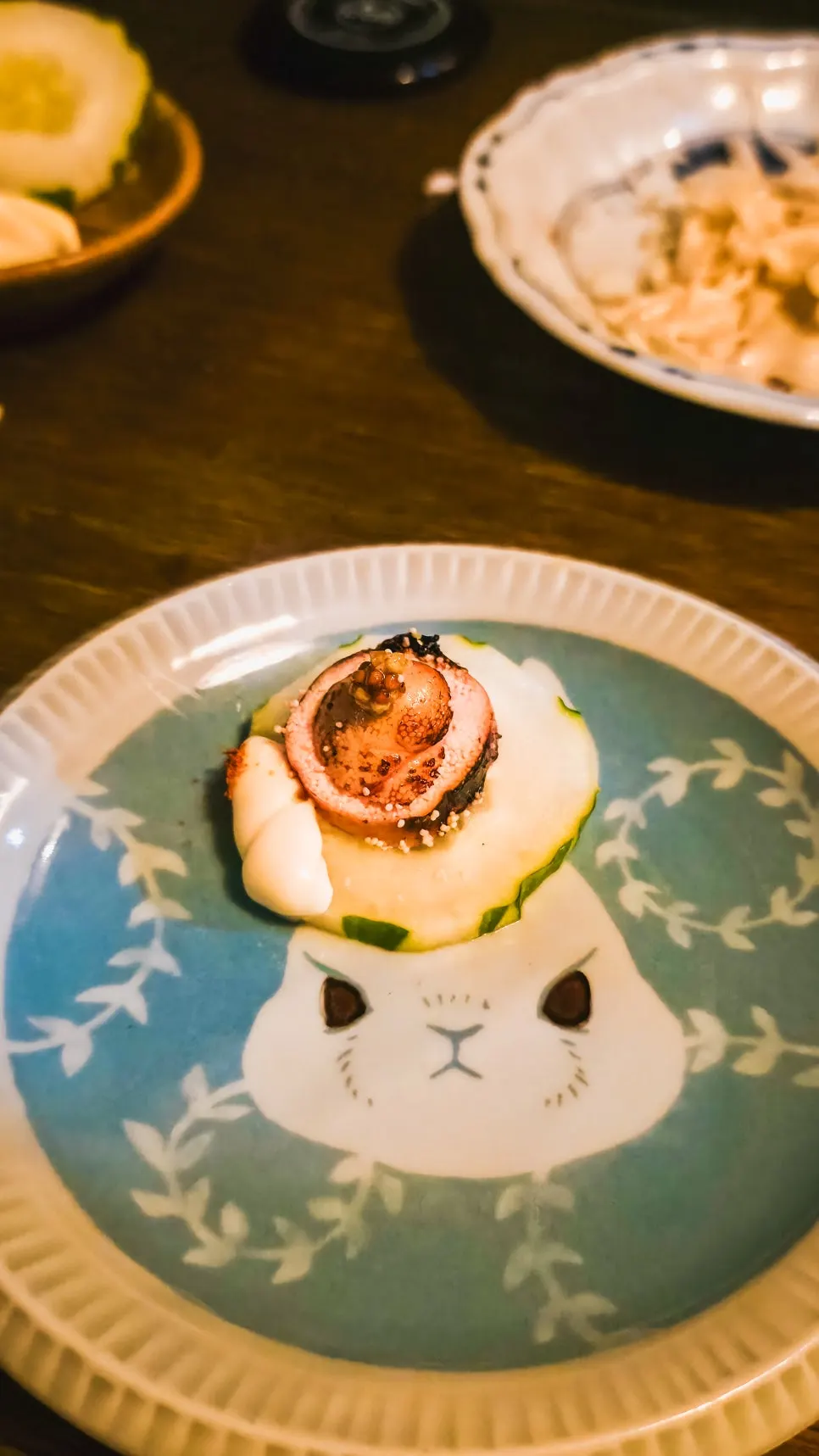 Two chunks of charcoal-grilled cod roe with sliced cucumber and shichimi mayonnaise