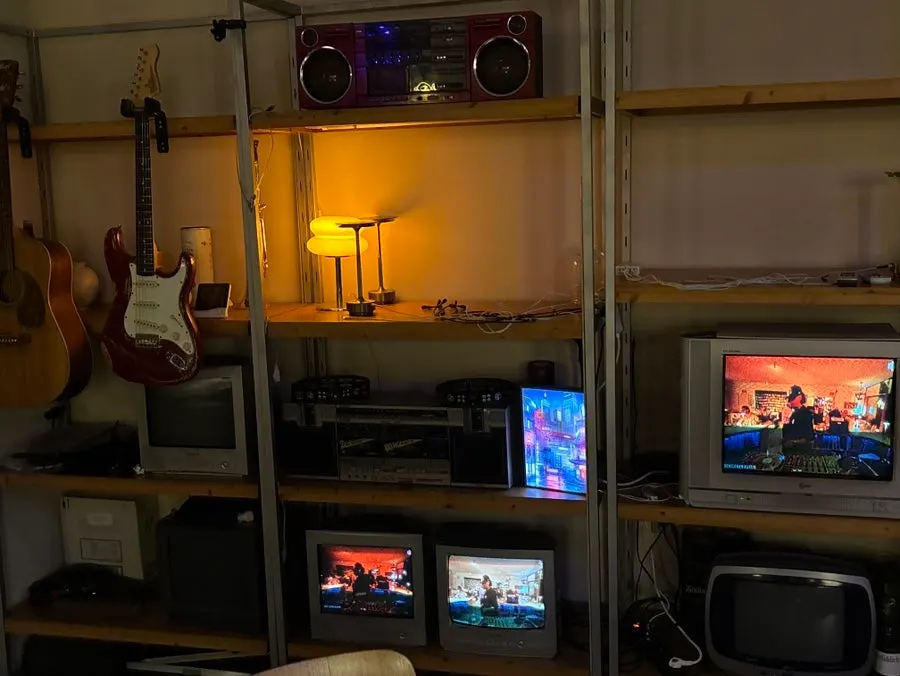 Shelf with a boombox and a guitar