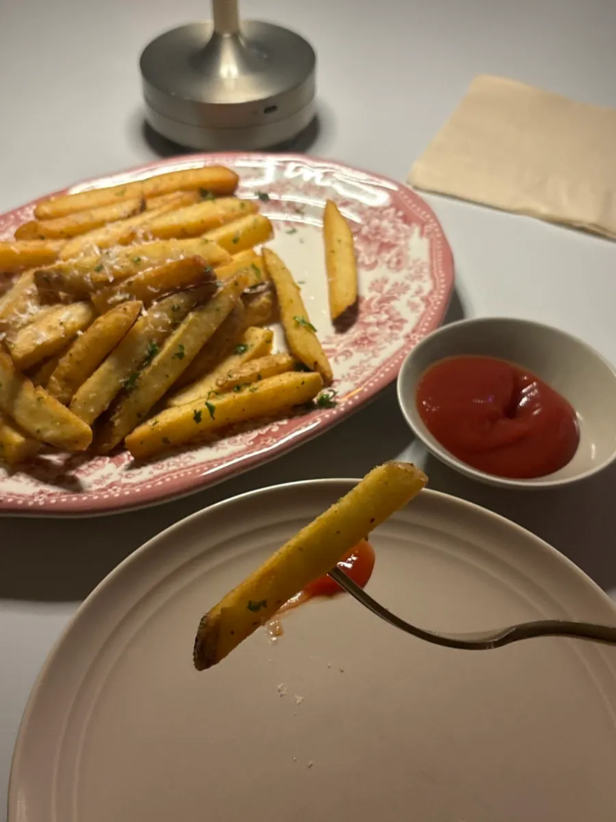 Truffle fries sprinkled with cheese powder and parsley