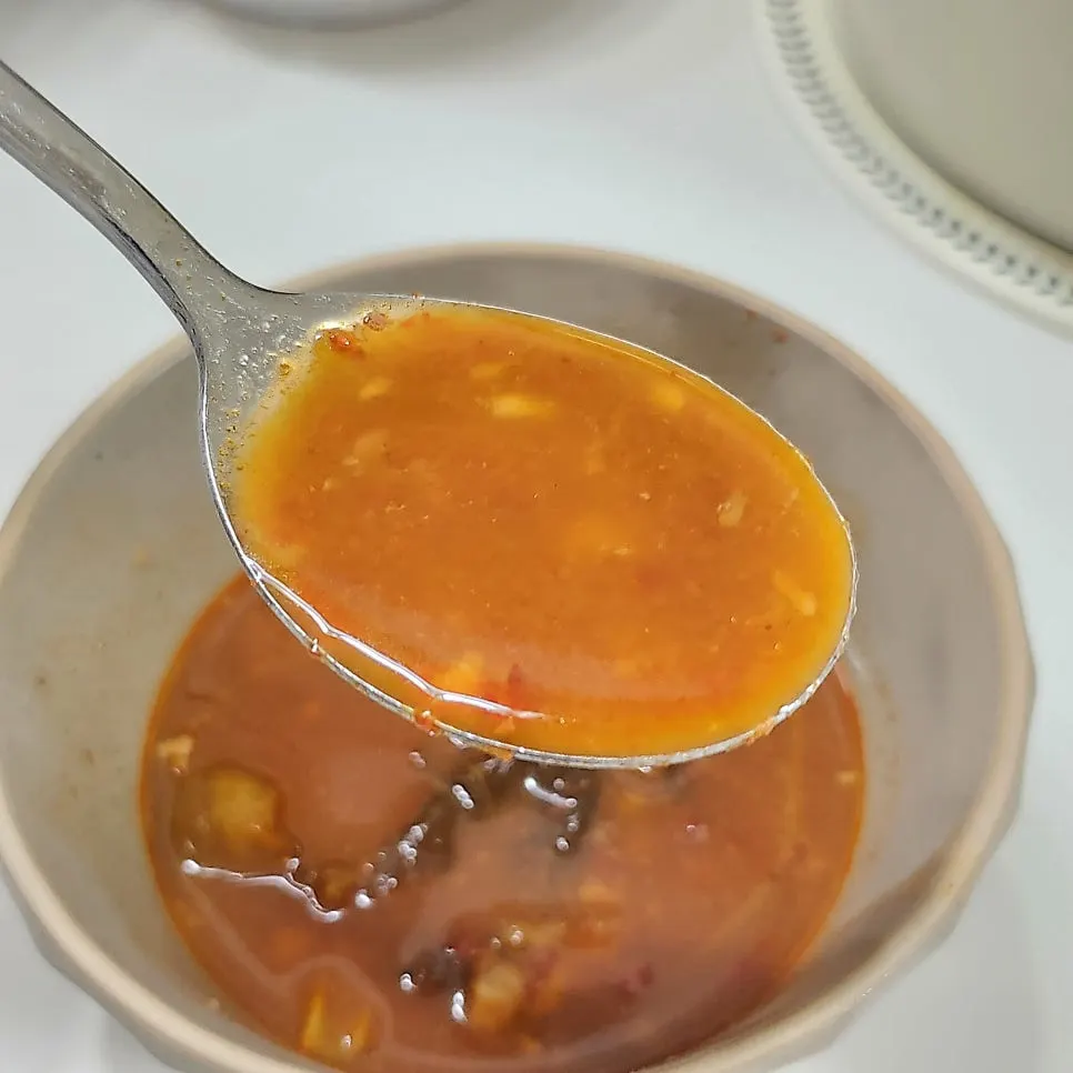 A piece of jokbal dipped in salted shrimp