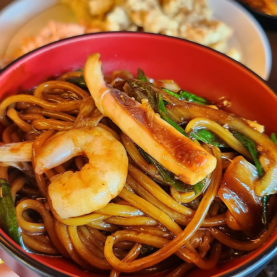 Noodles mixed with jjajang sauce on the stone plate