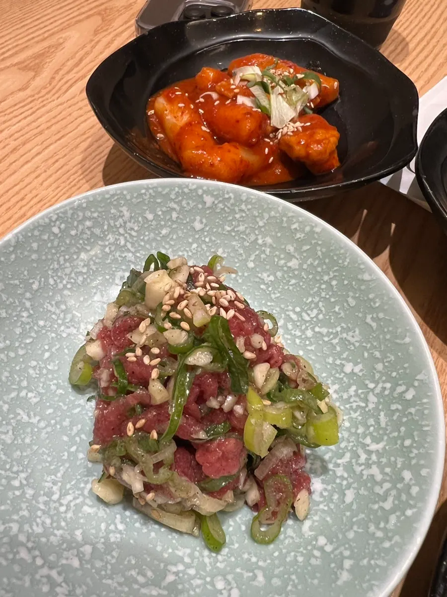 Tteokbokki, salad, yukhoe, and soy crab at Domo Sushi
