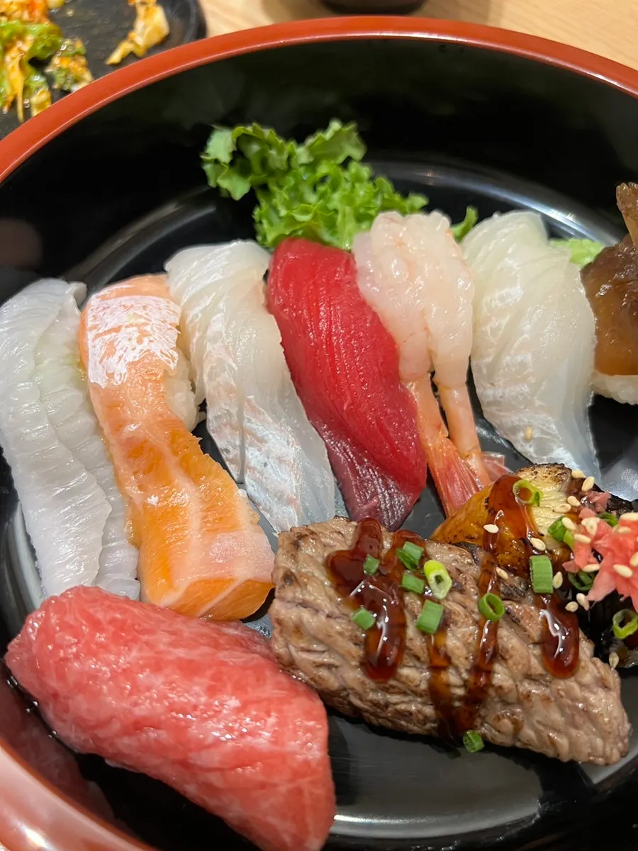 Sushi topped with long-sliced sashimi