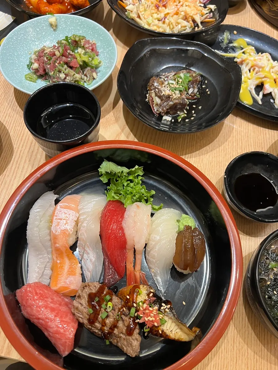 Picking up a piece of Domo Sushi's sushi