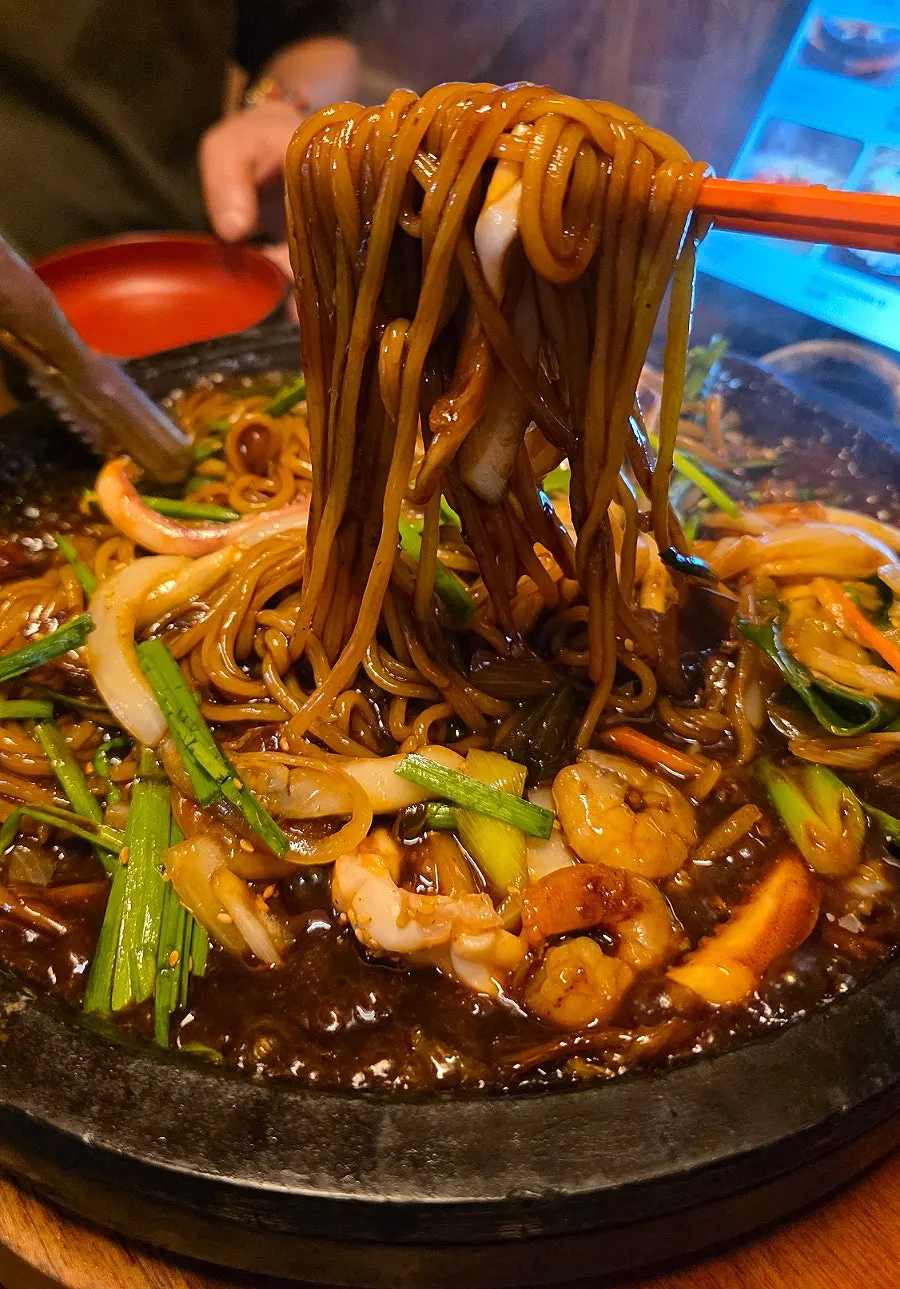 Stone-plate seafood jjajang piled high with seafood