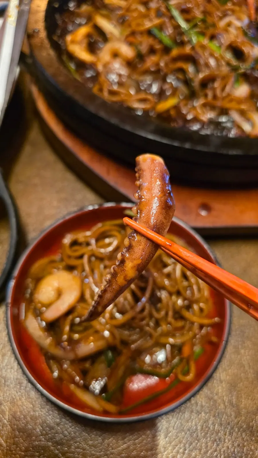 Chewy jjajang noodles lifted with chopsticks