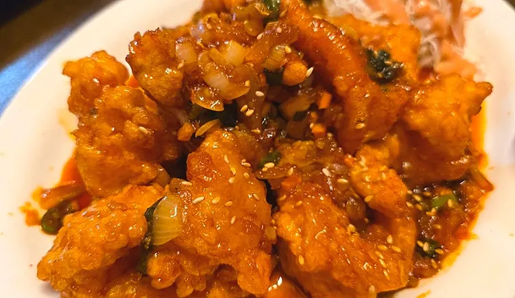 Close-up of shrimp coated in sweet-and-sour kkanpung sauce
