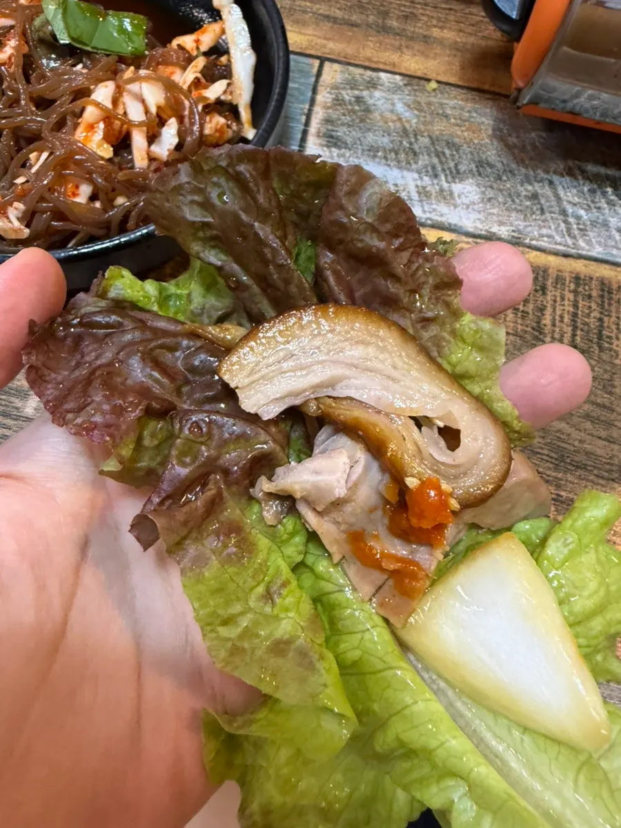 Jokbal wrapped in a lettuce leaf