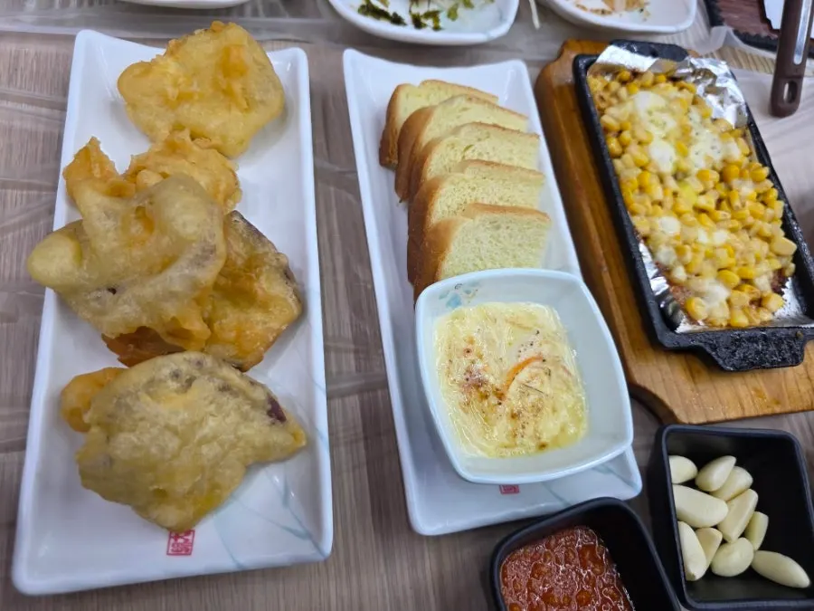 Plate of soy-marinated crab, seasoned raw fish, and salad