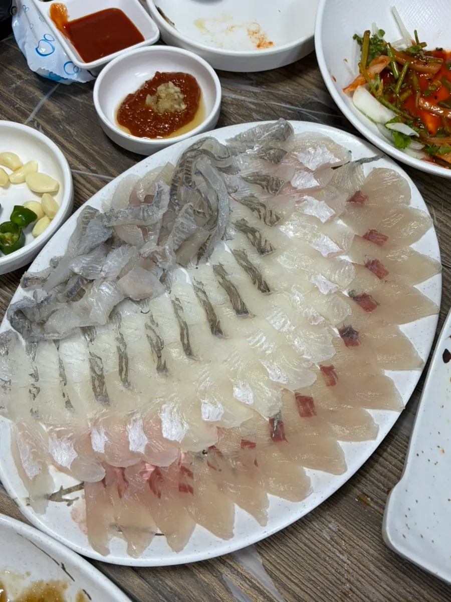 Course dishes including sushi and boiled squid