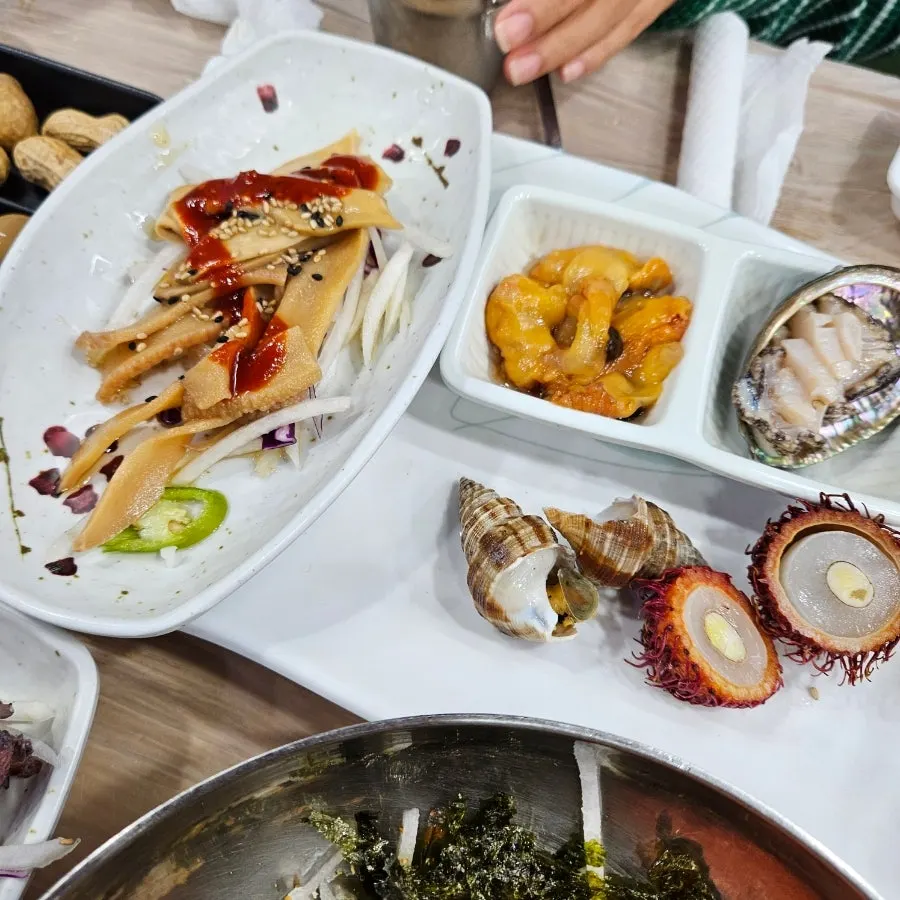 Soy-marinated crab and corn cheese among the drinking snacks