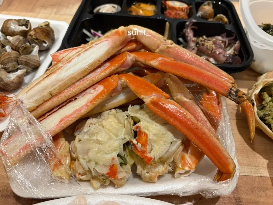 A spoonful of crab roe fried rice topped with crab meat