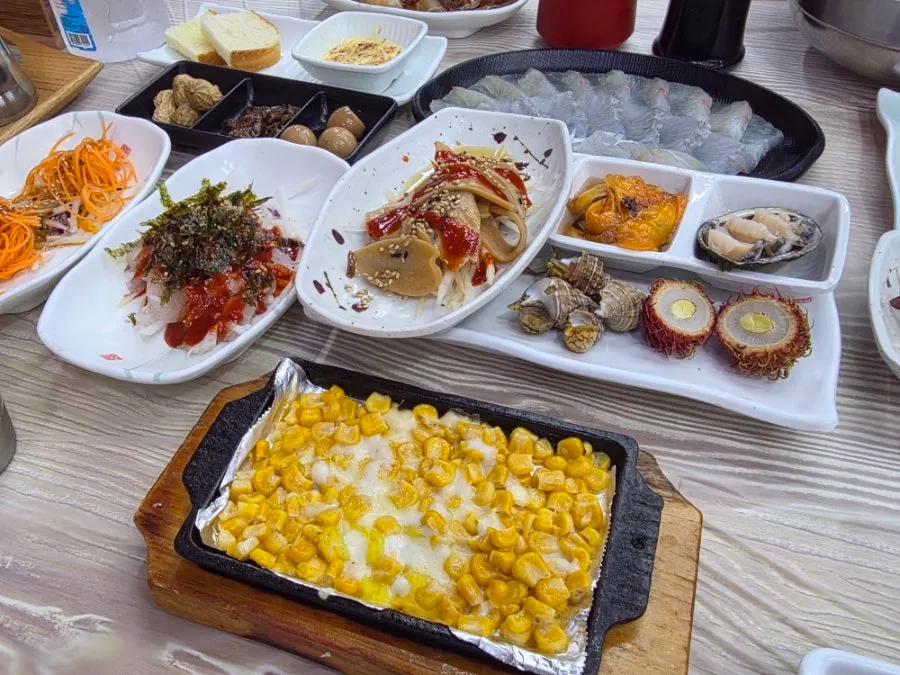 Plate of mini sashimi and seasoned sashimi side dishes