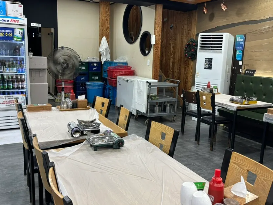 Interior walkway and tables at Gallilli Daegae Hoe Sikdang