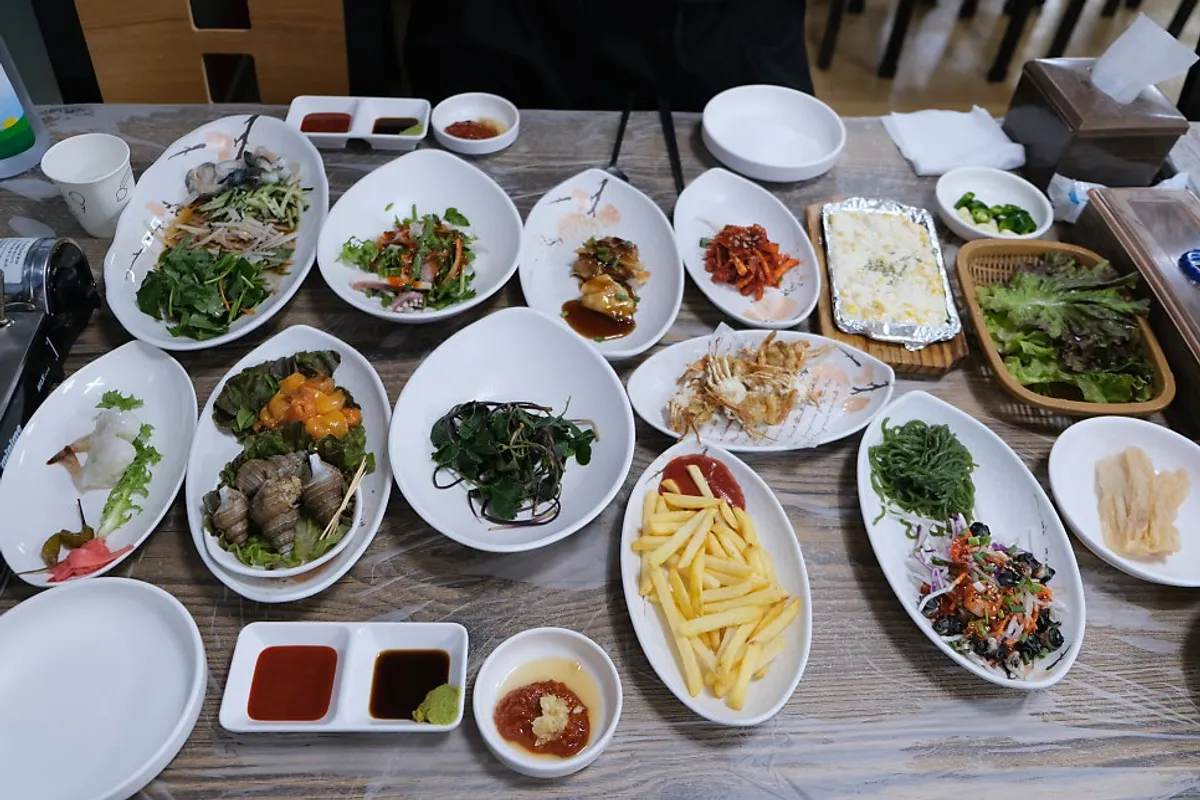 Table full of side dishes at the sashimi restaurant