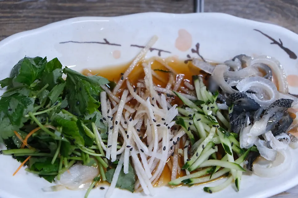 Deodeok root salad, grilled Chilean sea bass, and potato chips