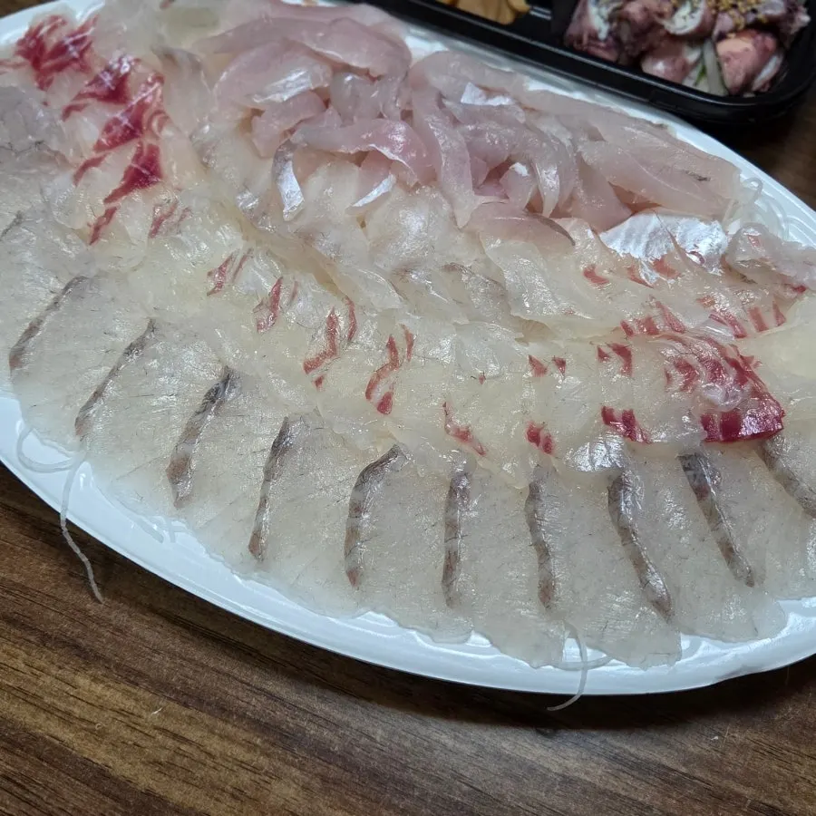 Table with sashimi and side dishes together