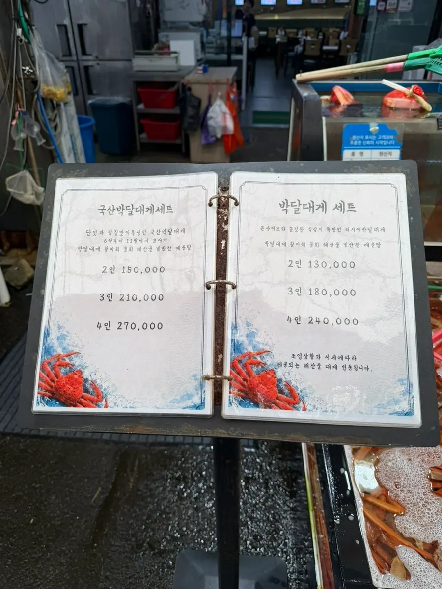 Checking the crab tank and price signs before ordering