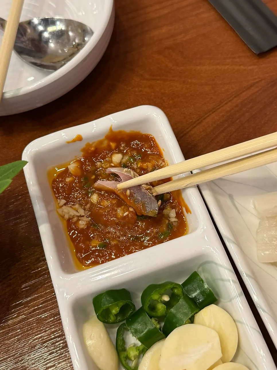 A piece of gizzard shad dipped in ssamjang