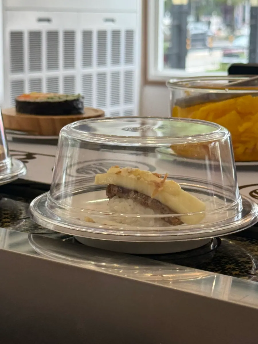A variety of sushi and desserts prepared