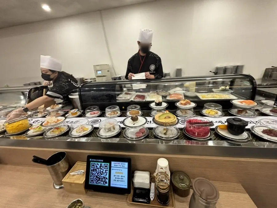 Sushi plates moving quickly along the rail