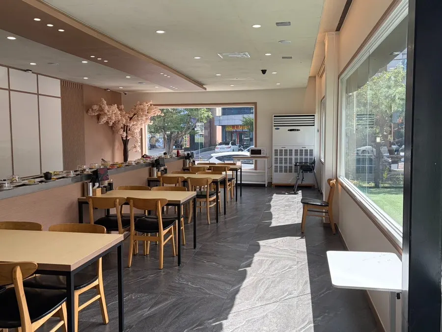 Bar seats facing the conveyor rail
