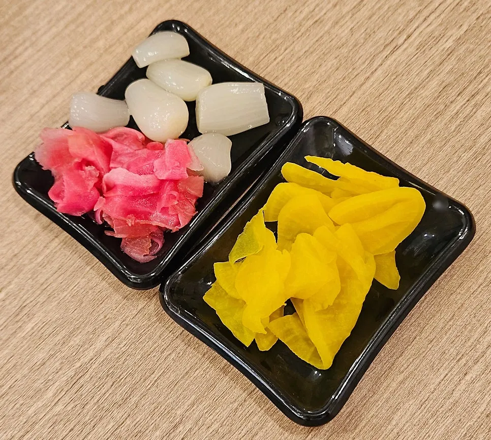 Various sushi menu items rotating on the conveyor rail