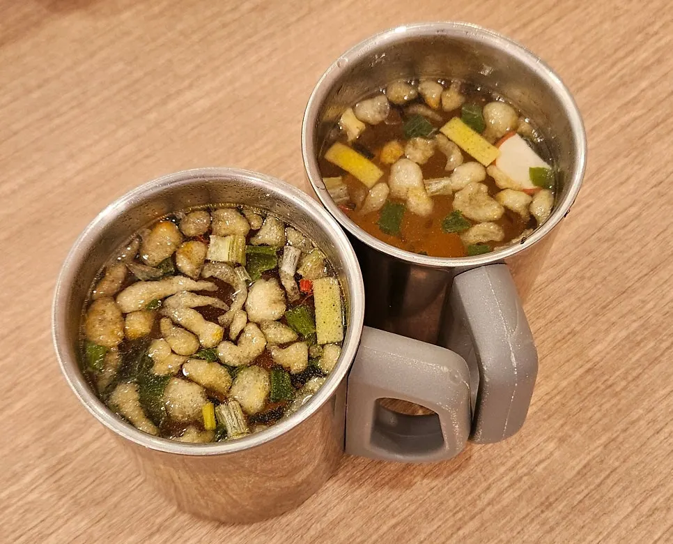 Basic table setup with udon broth served in a cup