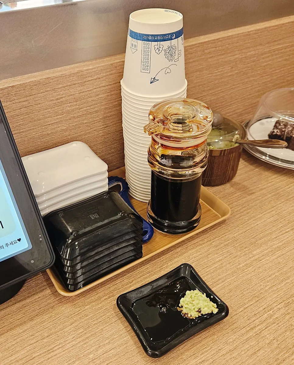 Bar seat set up with soy sauce and wasabi ready