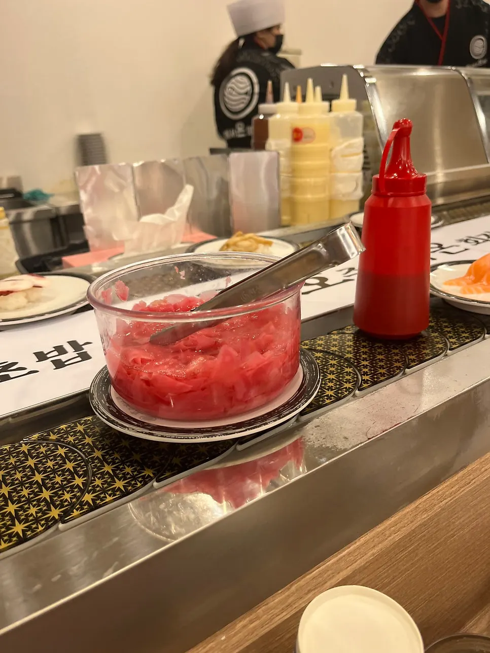 Sushi plates passing by on the conveyor belt