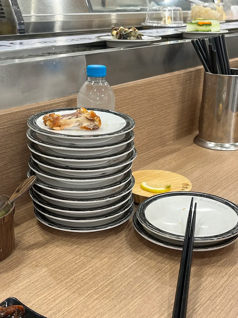 A tower of more than 10 empty plates stacked up