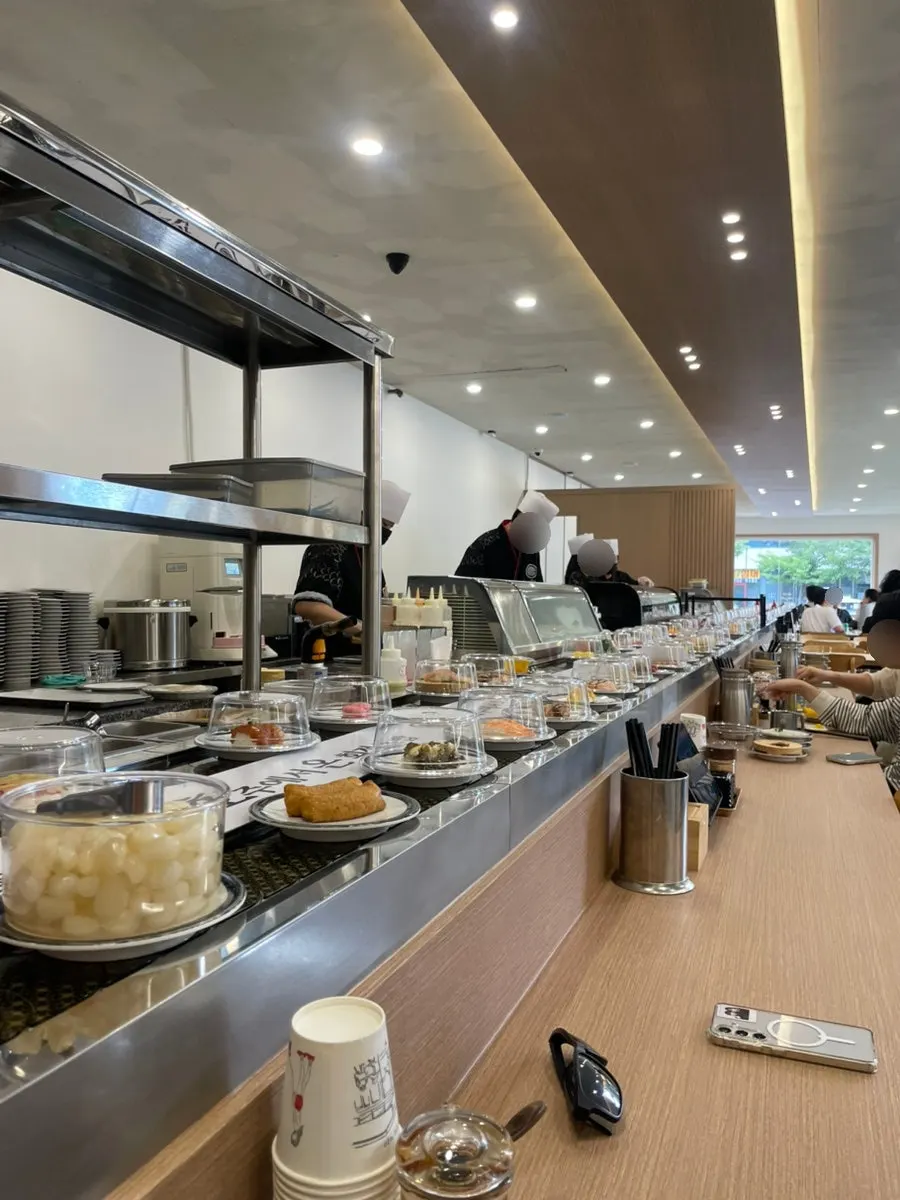 Conveyor-belt sushi rail in front of a table for two