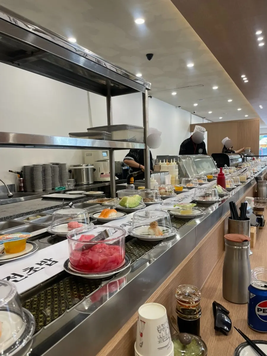 Conveyor-belt sushi area where sushi is made fresh