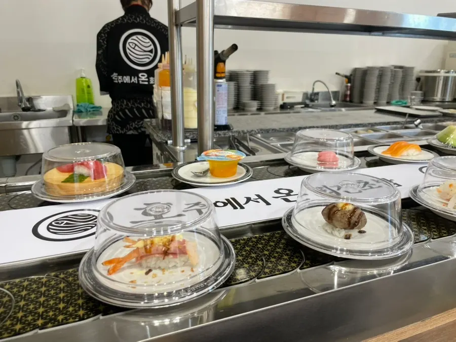 Conveyor belt with plenty of sushi to choose from