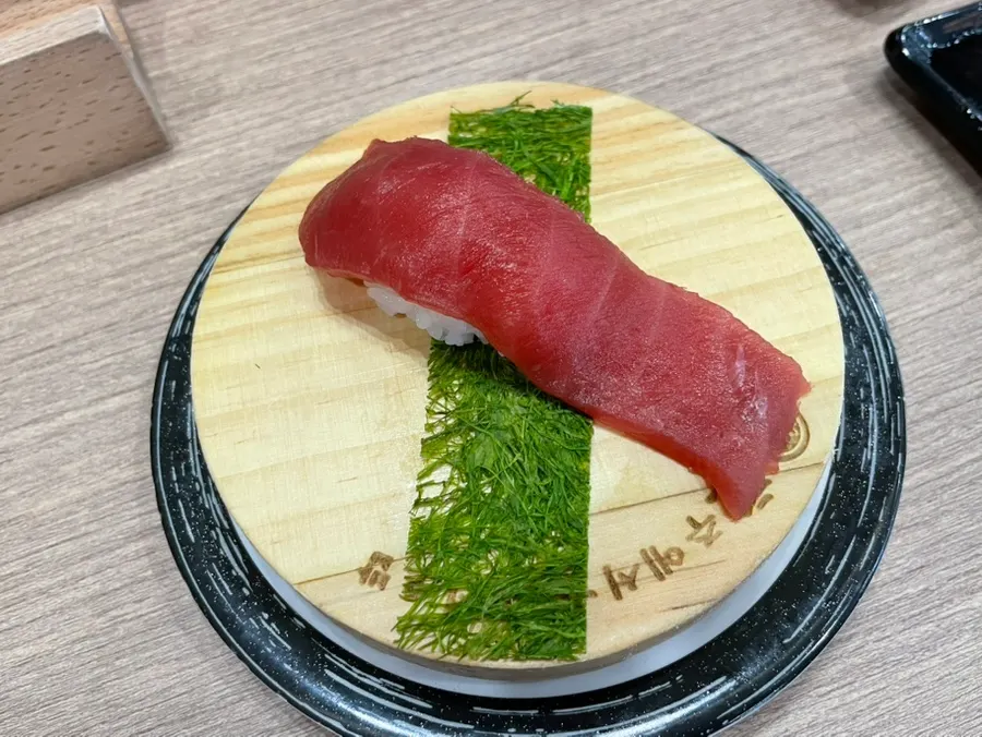 A conveyor-belt sushi plate including tuna sushi