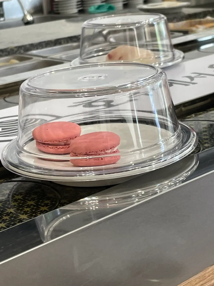 Desserts on the conveyor belt after the meal