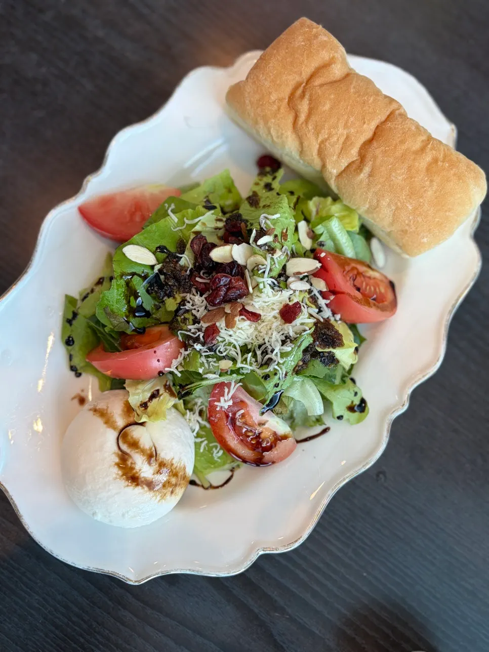 Burrata cheese salad topped over vegetables and tomatoes
