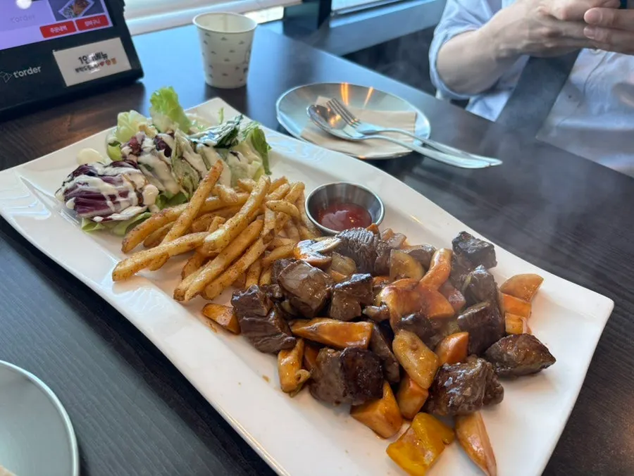 Chop steak and rosé pasta served on the table at Plan A Restaurant