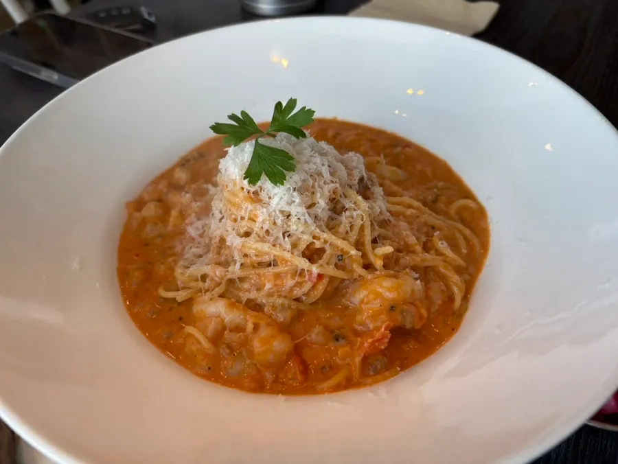 A full Western-style meal at a window seat with an ocean view