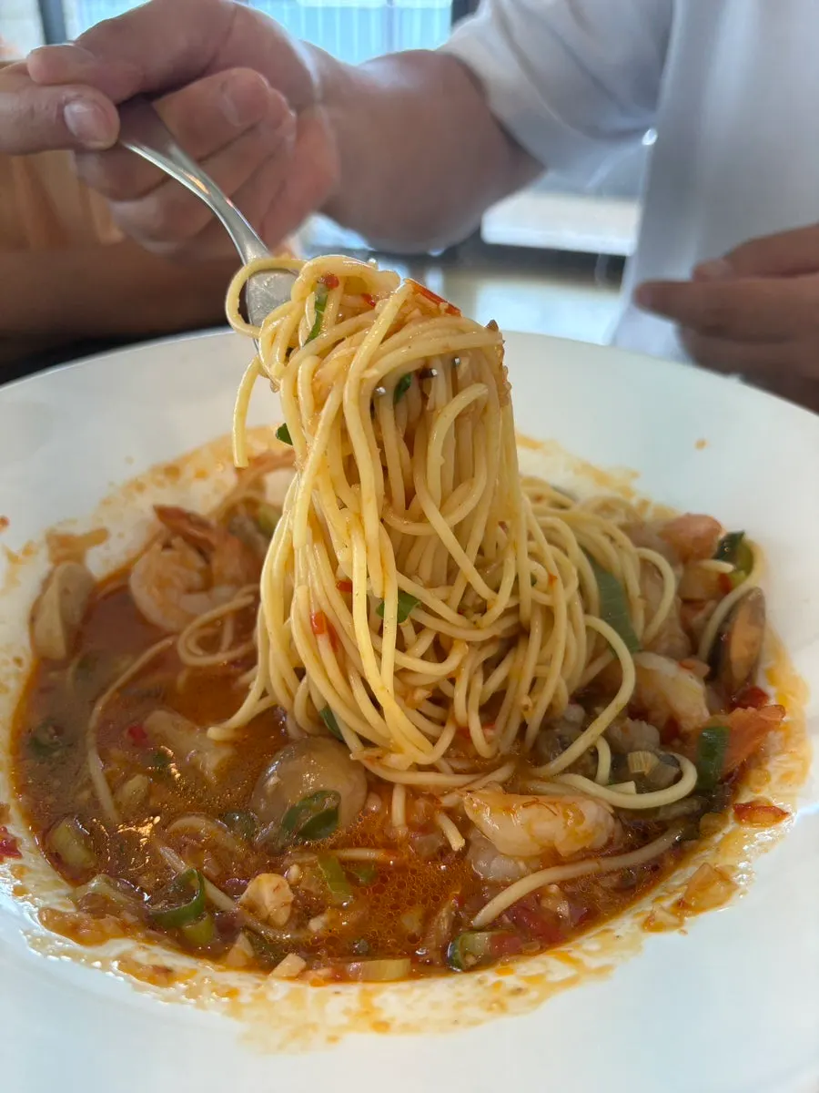 Close-up of the spicy broth in the shrimp soup spaghetti