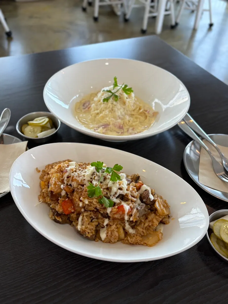 Three dishes served at a table with an ocean view