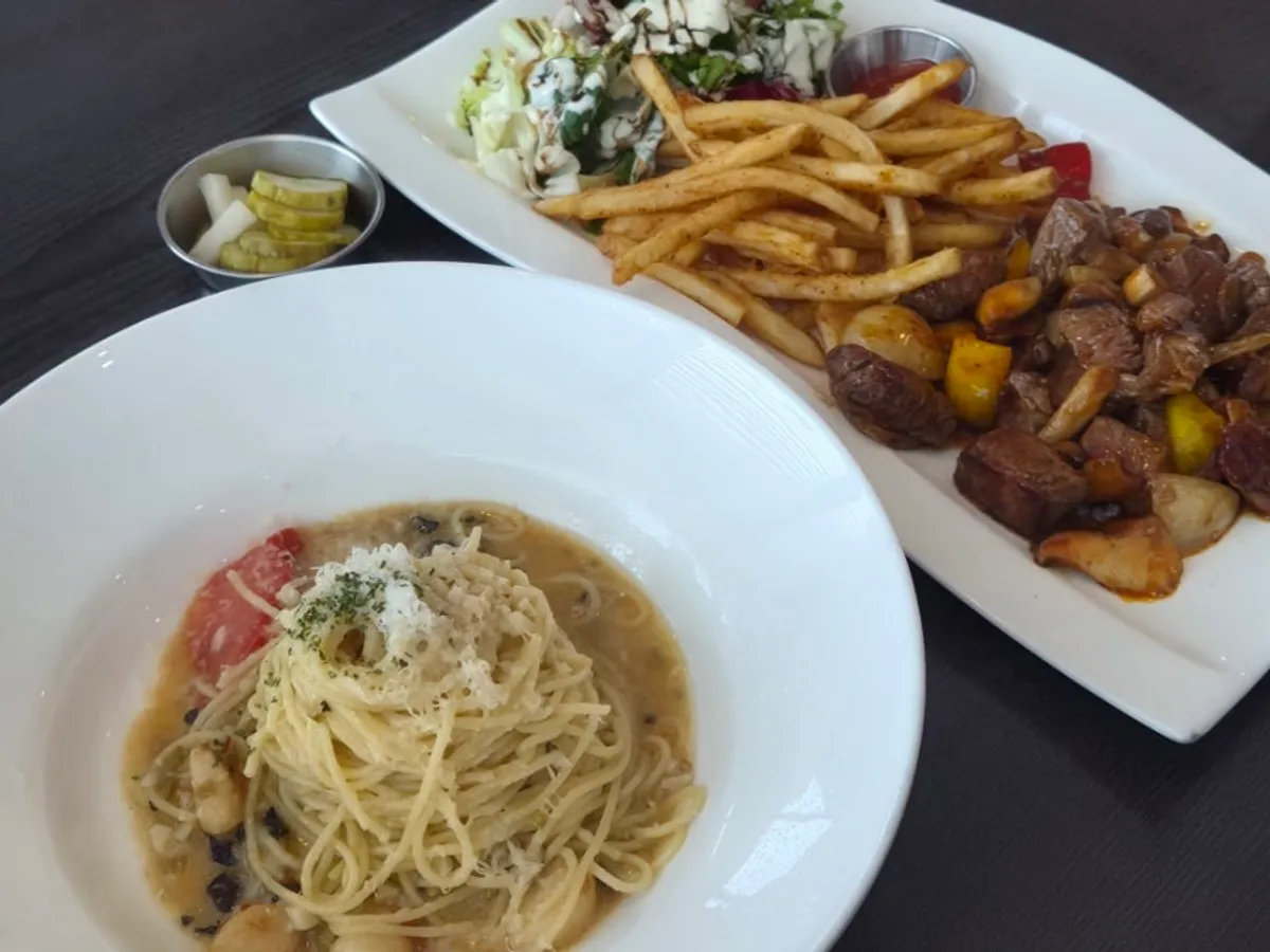 Table set with chop steak and truffle aglio olio