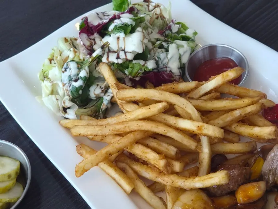 Fries and salad served with the chop steak