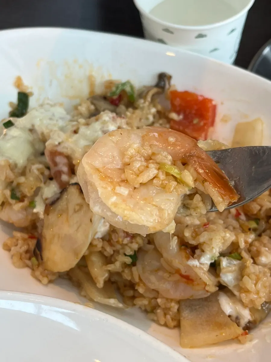 A spoonful of whole shrimp pilaf