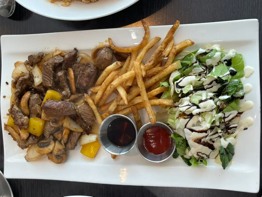 Beef chop steak served with fries and salad