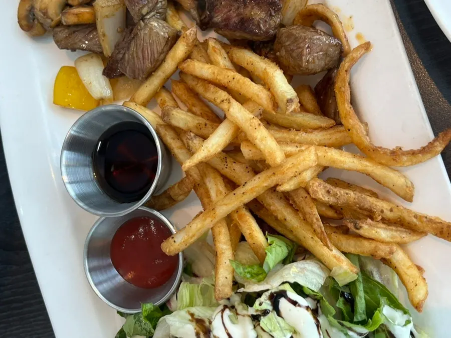 Fries and salad served alongside the chop steak