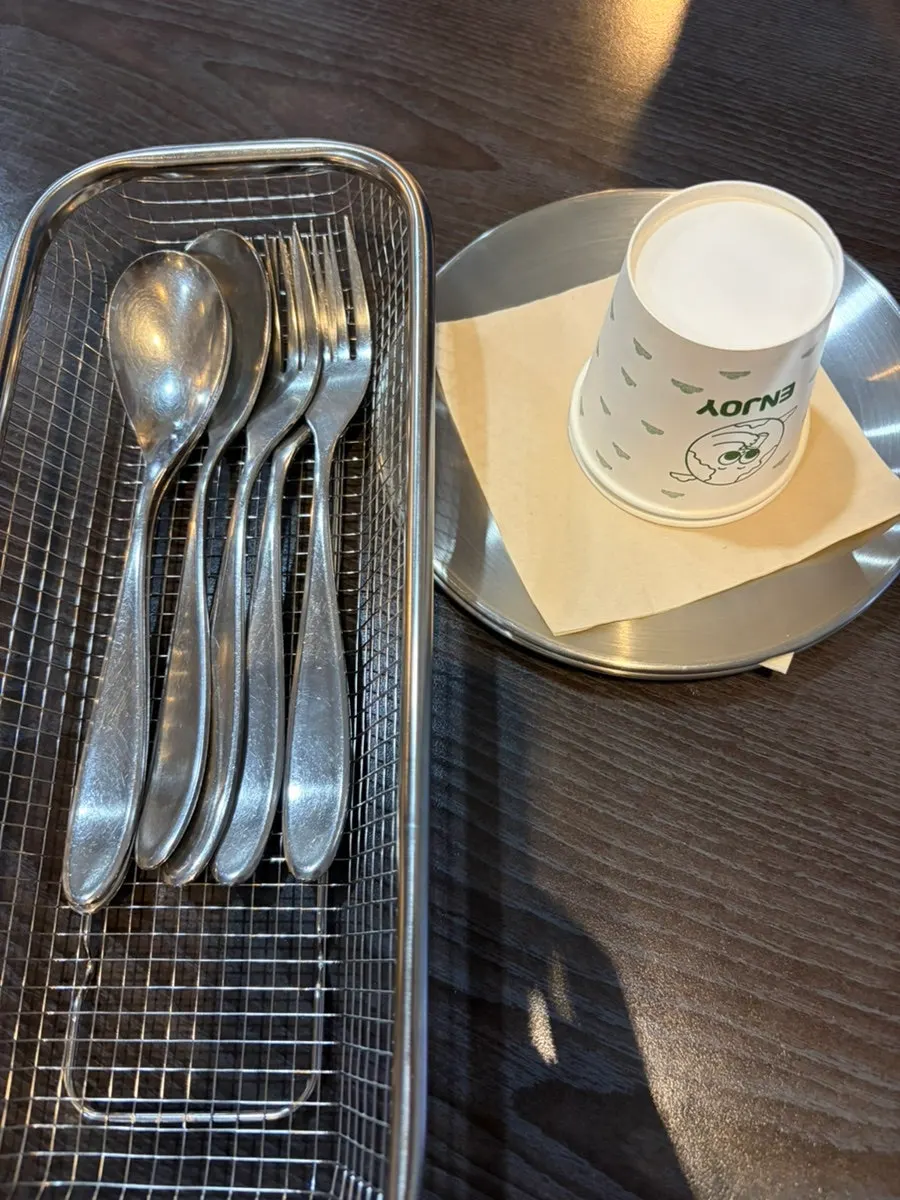Basic pickles and cider served in an ice-filled cup
