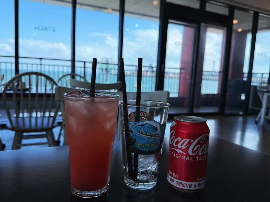 Grapefruit ade, cola, and a cup of ice on the table