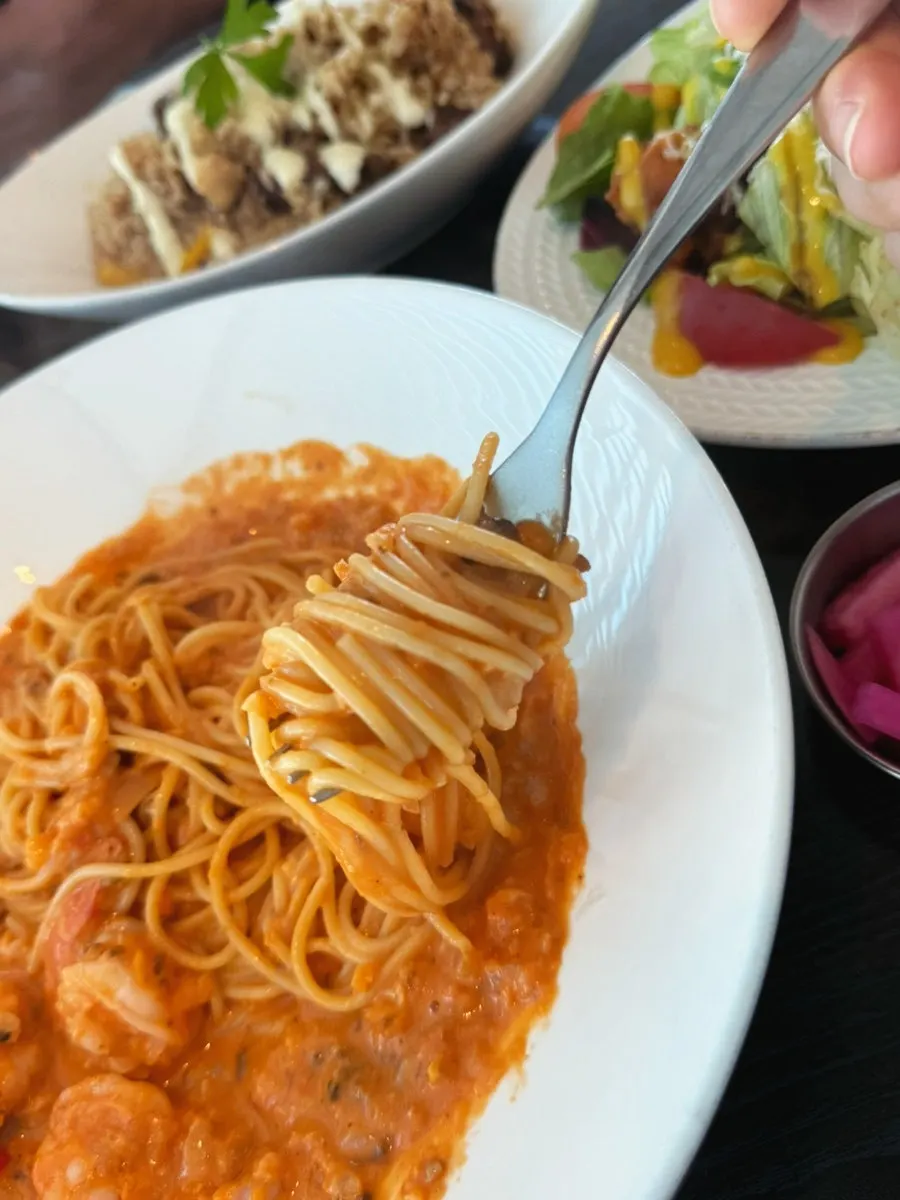 Close-up of pasta noodles coated in rosé sauce