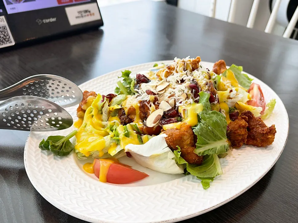 Chicken salad piled with crispy chicken and vegetables